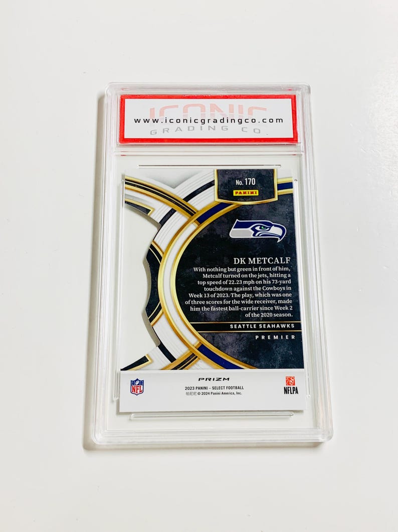 May include: A DK Metcalf football card from the Seattle Seahawks Premier series, graded by Iconic Grading Co. The card features a player image and details about a touchdown. The card is encased in a clear protective holder.