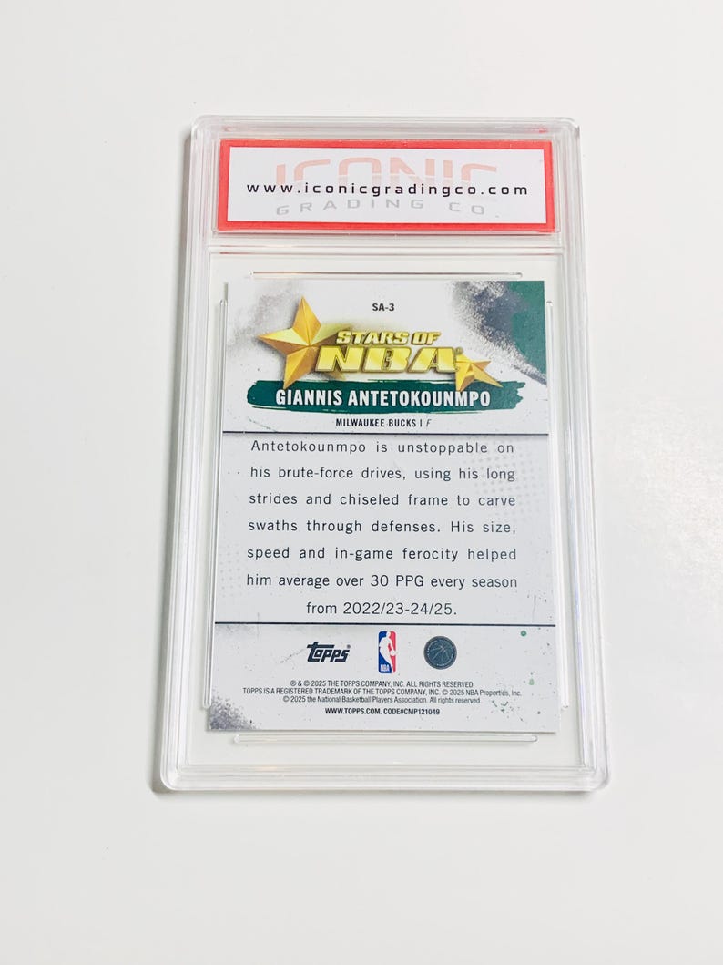 May include: A graded sports card featuring Giannis Antetokounmpo from the Milwaukee Bucks. The card is encased in a clear plastic holder with the Iconic Grading Co. logo at the top. The card's design includes the NBA logo and Topps branding.