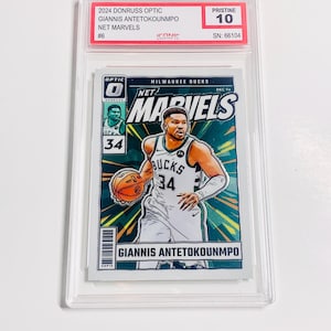 May include: A basketball trading card featuring Giannis Antetokounmpo in a Milwaukee Bucks uniform. The card is from the 2024 Donruss Optic Net Marvels series, graded Pristine 10. The card has a vibrant design with the player's name and team details.