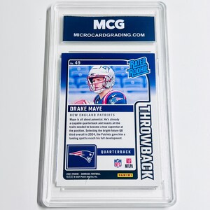 May include: A graded football card featuring Drake Maye of the New England Patriots. The card is encased in a clear protective holder and includes the text "THROWBACK" and "RATED ROOKIE". The card also has the text "MCG MICROCARDGRADING.COM".