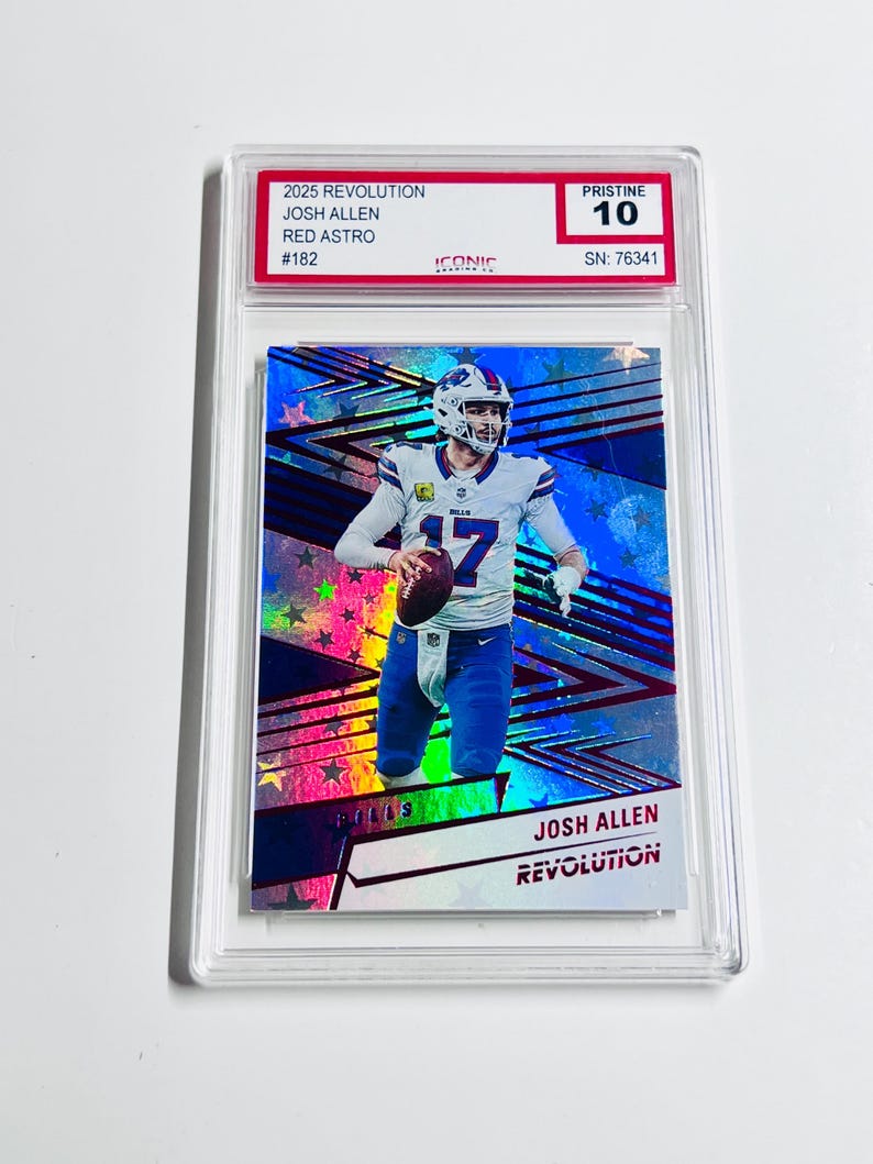 May include: A graded Josh Allen football card from the 2025 Revolution series. The card features a player image with a blue and silver holographic design. The card is graded Pristine 10, with the text "JOSH ALLEN" and "REVOLUTION".