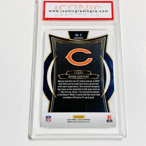 May include: A graded football card featuring Rome Odunze of the Chicago Bears. The card is encased in a clear plastic holder with the "ICONIC GRADING CO." logo at the top. The card's design includes the team logo and player information.