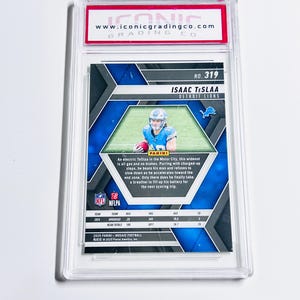 May include: A graded Isaac TeSlaa Detroit Lions football card. The card features a photo of the player in a blue uniform. The card is encased in a clear plastic holder with the Iconic Grading Co. logo.