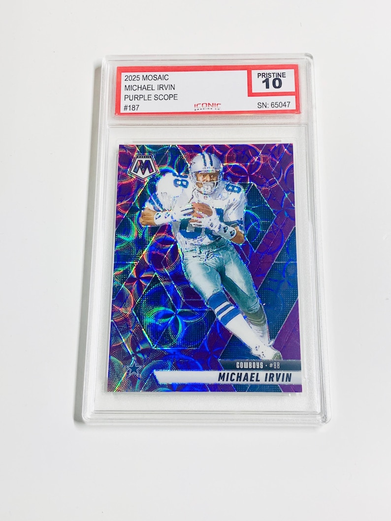 May include: A Michael Irvin football card from the 2025 Mosaic set, featuring a purple scope design. The card is graded Pristine 10 and encased in a protective holder. The card has the text "MICHAEL IRVIN" and "COWBOYS #88".