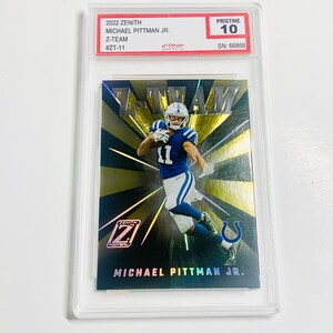 May include: A 2022 Zenith Michael Pittman Jr. Z-Team football trading card, graded Pristine 10, encased in a protective holder. The card features a player in a blue and white uniform against a gold and black background.