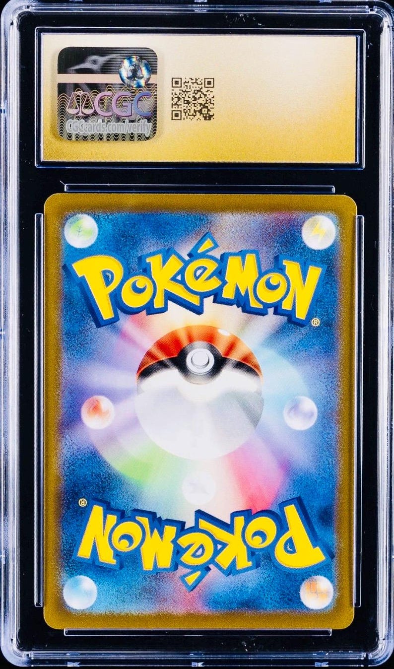 May include: A graded Pok&eacute;mon trading card in a clear protective case. The card displays the Pok&eacute;mon logo in yellow and blue, with a Pok&eacute; Ball design. The holder has a gold border and a CGC logo sticker.