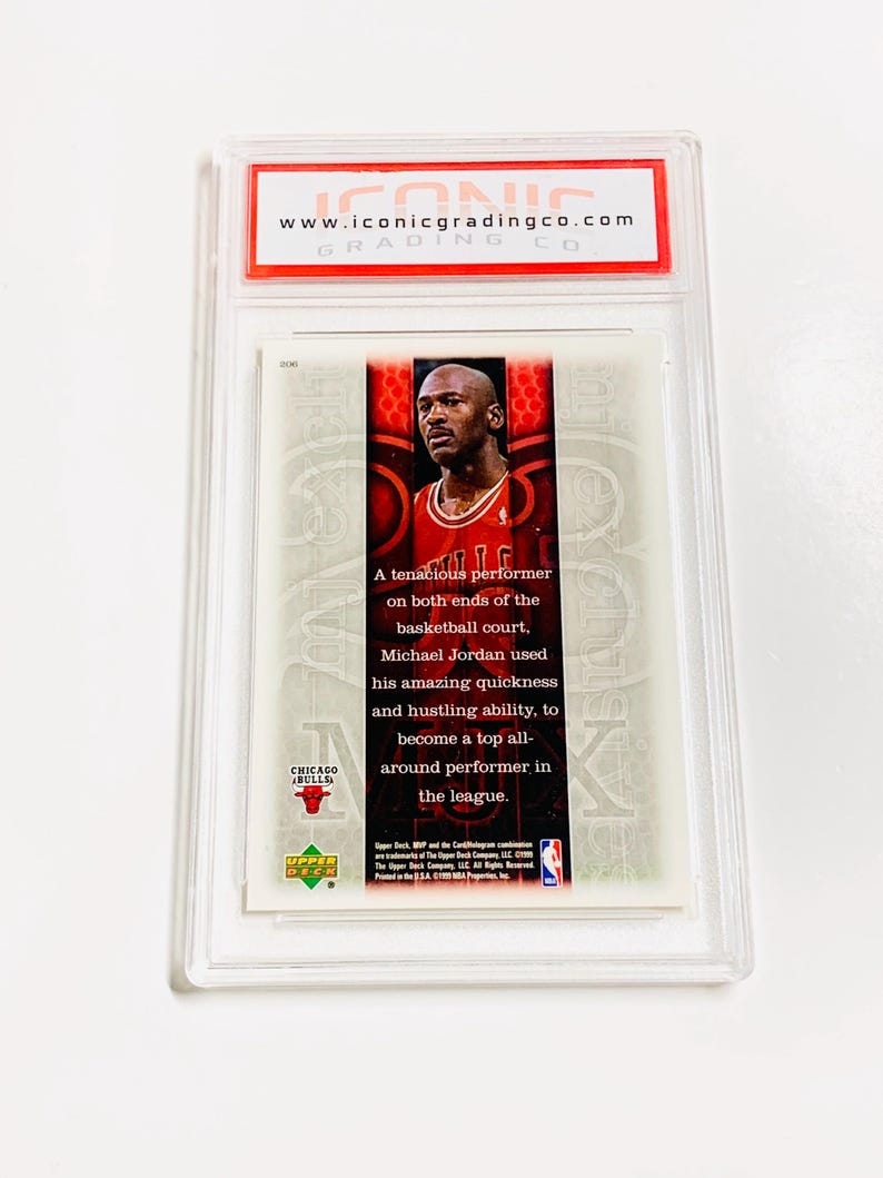 May include: A graded Upper Deck basketball card featuring Michael Jordan in a Chicago Bulls uniform. The card is encased in a clear plastic holder with the text "www.iconicgradingco.com" visible at the top. The card text describes Jordan's performance.