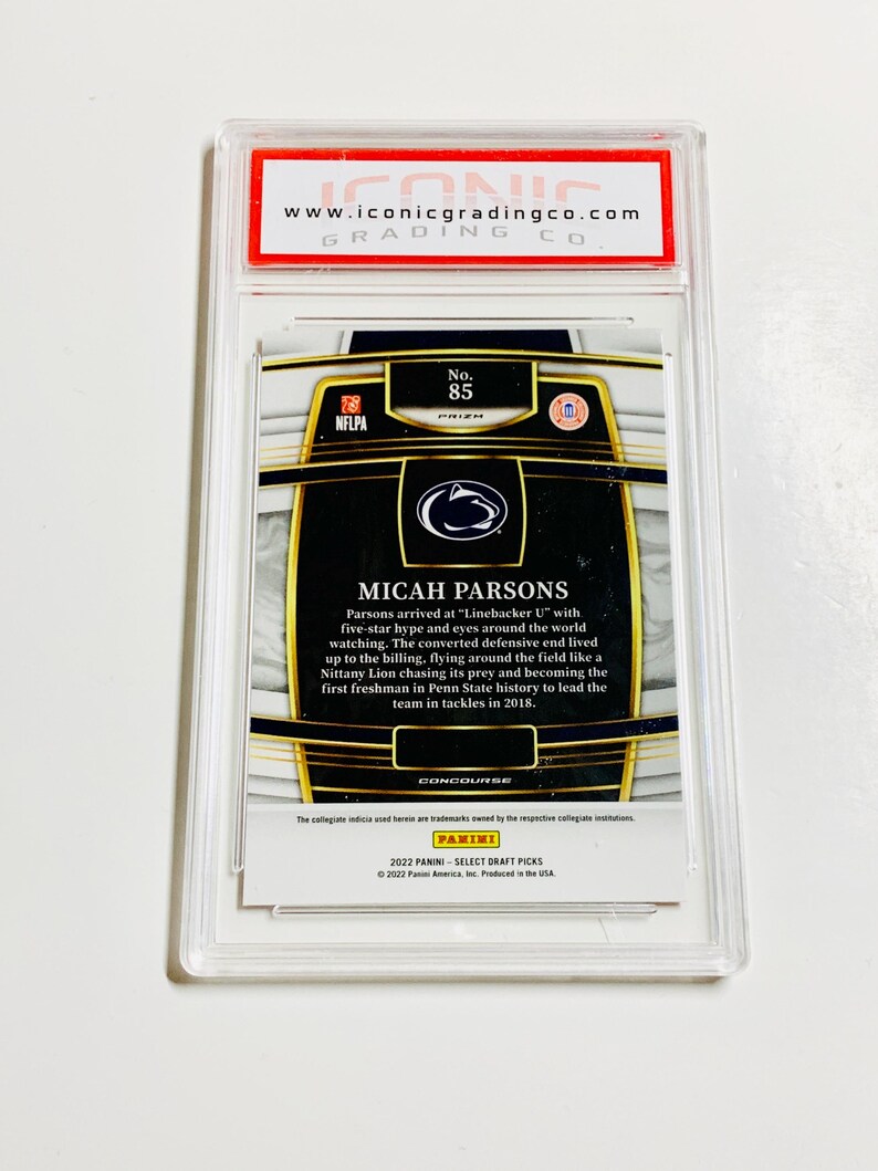 May include: A graded sports trading card featuring Micah Parsons, a football player. The card is encased in a clear plastic holder with the text "MICAH PARSONS" and "2022 PANINI - SELECT DRAFT PICKS". The card is graded by Iconic Grading Co.