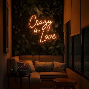 Custom neon sign  for balcony that reads “Crazy in Love” in Orange color neon LED light, Halaa neon sign (the Shop) offer handmade wall decor of any design for all occasions for home, wedding neon sign, business logo neon sign, or event. Personalized neon light sign, aesthetic glowing signage, unique gift idea, modern custom lighting that is made to order