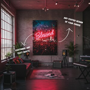 May include: A large poster with the word "Blessed" in red neon against a backdrop of a crowd and city skyline. The poster is displayed in a room with a couch, plants, and audio equipment. The text "Customize any text/quote" is also visible.
