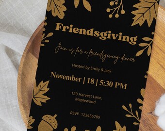 May include: A black Friendsgiving invitation with gold leaf and acorn accents. The invitation includes the text "Friendsgiving," details for a dinner hosted by Emily & Jack, and the date and time: November 18 at 5:30 PM.
