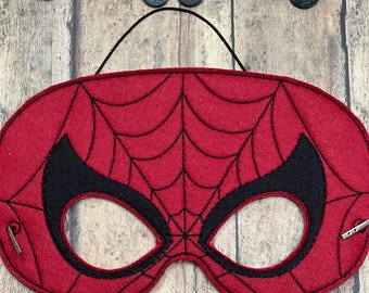 May include: Red felt Spiderman mask with black webbing and eye holes. The mask has a black elastic strap for wearing.