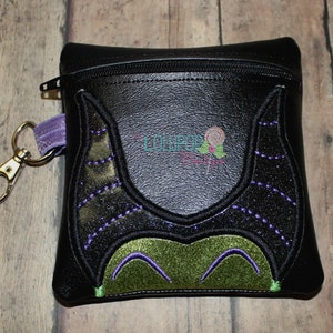 May include: Black zippered pouch with a green and purple embroidered design of Maleficent's horns and face.