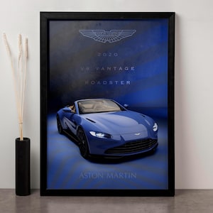 May include: A blue 2020 Aston Martin V8 Vantage Roadster with a black frame around the image. The car is on a blue background with the Aston Martin logo and text.