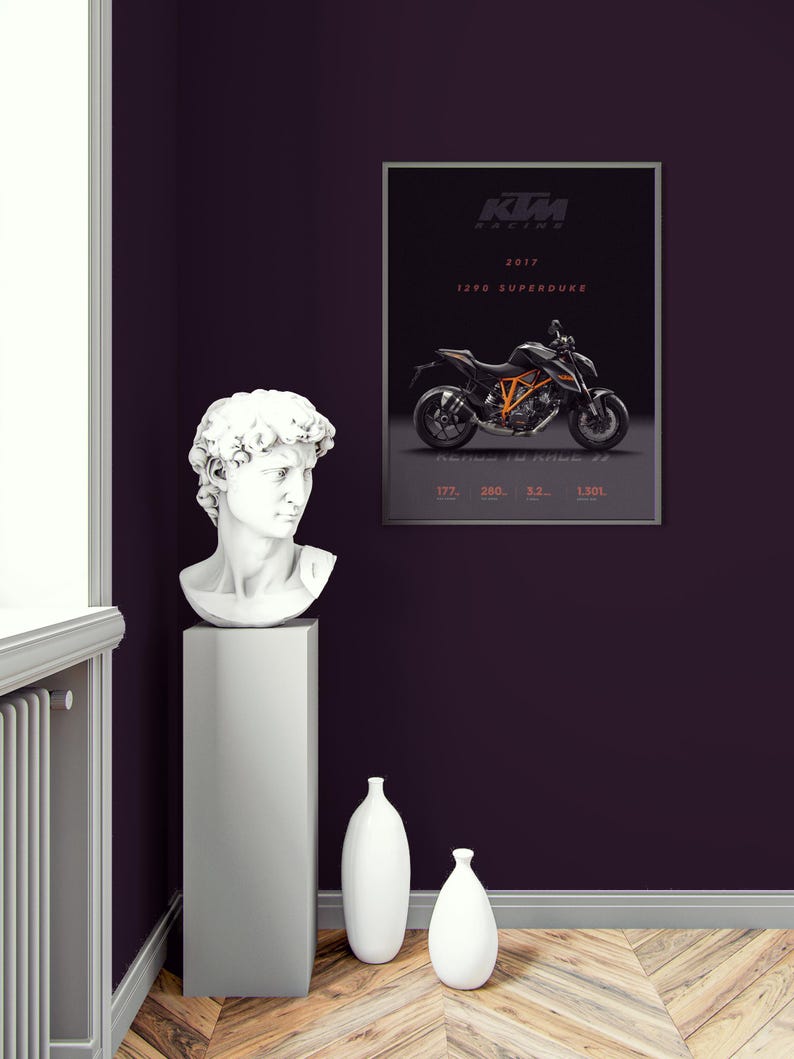 May include: A black and orange KTM 1290 Superduke motorcycle poster with the text "KTM Racing 2017 1290 Superduke" on a dark purple wall with a white plaster bust of a man on a gray pedestal and two white vases on the wooden floor.