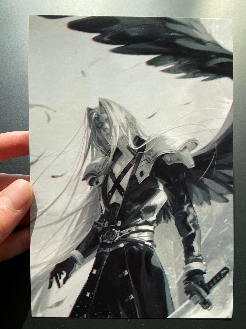 May include: Black and white illustration of a character with long silver hair, wearing a black coat and armor, holding a sword. The character has a wing-like structure behind them, with feathers floating in the air. The image is held by a hand.