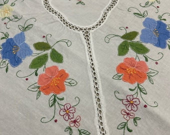 White Cotton Tablecloth with Pastel Applique Flowers, Embroidery and Cutwork Filled with White Crochet.  Measures 64" X 80"