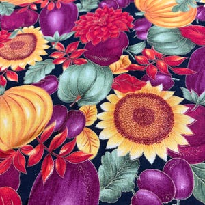 May include: A fabric print featuring a repeating pattern of yellow sunflowers, orange pumpkins, green gourds, and deep purple plums against a black background. The design includes red and green leaves with gold glitter accents throughout the surface.