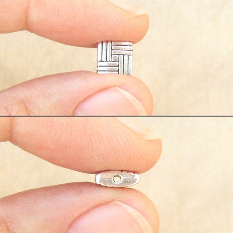 8 millimeter puff square beads with a basketweave design with fingers for scale