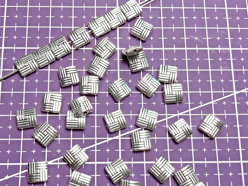 8 millimeter puff square beads with a basketweave design