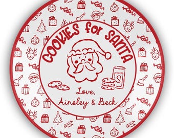 May include: A white ceramic plate with a red rim and a festive design. The plate features a repeating pattern of Christmas icons and the text "COOKIES FOR SANTA" in red. A Santa Claus illustration is in the center, with the names "Ainsley & Beck" below.