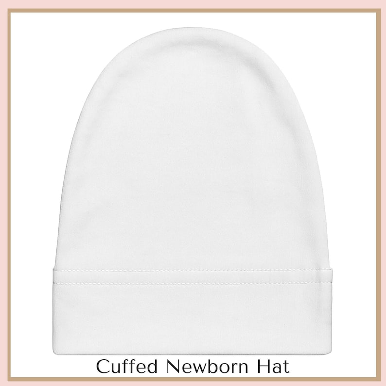 A white, cuffed newborn hat is shown against a white background.