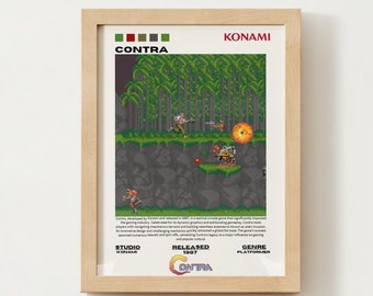 May include: A framed poster with a pixelated image of a video game called "Contra" from 1987. The poster is in a wooden frame and has a white background. The game is a platformer and was developed by Konami.