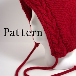 May include: Red knitted hooded hat with a cable knit pattern and long ties. The hat is on a white mannequin head. The word "Pattern" is written in black text below the hat.