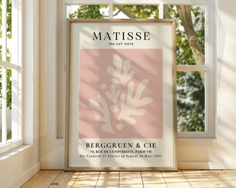 Op de afbeelding: Een roze en witte poster met de tekst "MATISSE the CUT-OUTS" en "BERGGRUEN & CIE 70, RUE DE L'UNIVERSITE, PARIS VII Du Vendredi 27 Février au Samedi 28 Mars 1953". De poster toont een wit abstract ontwerp van een plant op een roze achtergrond.