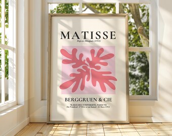 Op de afbeelding: Een roze en witte poster met een rood abstract ontwerp. De poster bevat de tekst "MATISSE Papers Découpés (1953)" en "BERGGRUEN & CIE 70, RUE DE L'UNIVERSITÉ, PARIS-VII Du Vendred 27 Fövr er an Samed 28 Mars 1953".