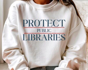 May include: White sweatshirt with the text "PROTECT PUBLIC LIBRARIES" in blue and red.