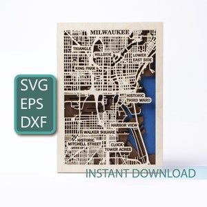 May include: A laser cut wooden map of Milwaukee, Wisconsin. The map shows the city's streets and neighborhoods, including the Historic Third Ward, Walker Square, and Harbor View. The map is a light brown color with a blue water feature. The text "INSTANT DOWNLOAD" is at the bottom of the map.