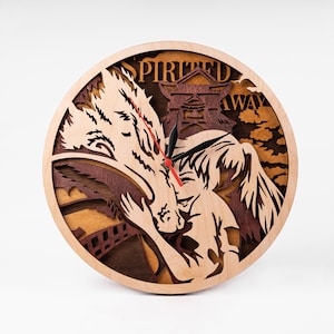 May include: A wooden wall clock featuring a stylized image of Chihiro from the animated film Spirited Away, embracing the spirit No Face. The clock face is surrounded by a wooden frame with the words "Spirited Away" inscribed on it.