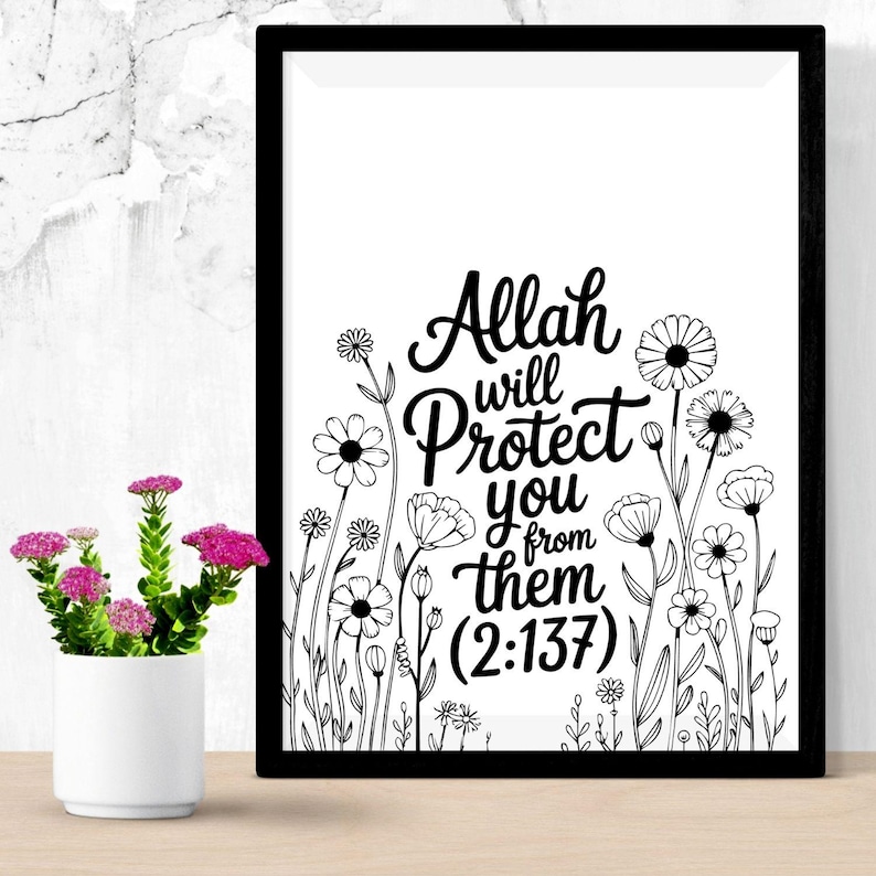 May include: Black framed art print with the text "Allah will protect you from them (2:137)" in a cursive font, surrounded by black and white floral illustrations. A small white vase with pink flowers sits to the left.