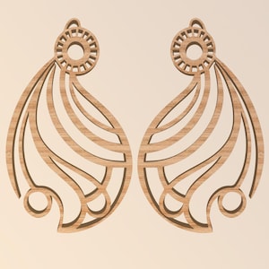 May include: Two wooden earrings with a light brown finish. Each earring features a circular top with a decorative pattern and a stylized wing shape with curved lines and a rounded bottom. The earrings are symmetrical and have a natural wood grain.