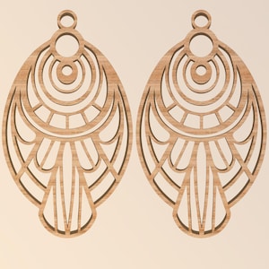 May include: Two wooden earrings with an intricate, openwork design. Each earring is an elongated oval shape with a series of concentric circles and geometric patterns. The earrings are a light brown color and have a small loop at the top for hanging.