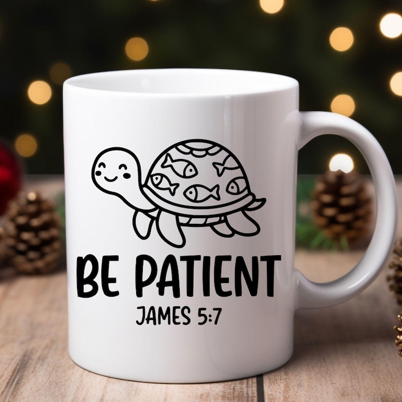 May include: White ceramic mug featuring a black and white cartoon turtle with fish on its shell. The mug has the text "BE PATIENT" and "JAMES 5:7" printed in black.