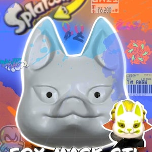 Könnte beinhalten: Werbung für einen digitalen Download einer Fuchsmaske-STL-Datei. Das Bild zeigt eine weiße Fuchsmaske mit blauen Details, eine kleinere Version der Maske und den Text "FOX MASK STL". Der Hintergrund ist orange und blau mit dem Branding "Splatoon 3".