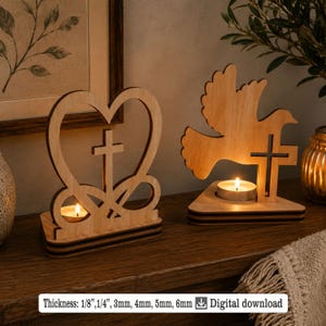 May include: Two wooden candle holders. One is heart-shaped with a cross, the other is a dove with a cross. Each holds a lit tea light. The text "Thickness: 1/8", 1/4", 3mm, 4mm, 5mm, 6mm Digital download" is at the bottom.