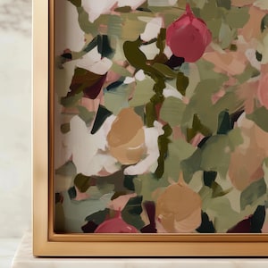 May include: Abstract floral painting in a gold frame. The artwork features brushstrokes of pink, white, green, and tan. The painting is displayed on a white marble surface.