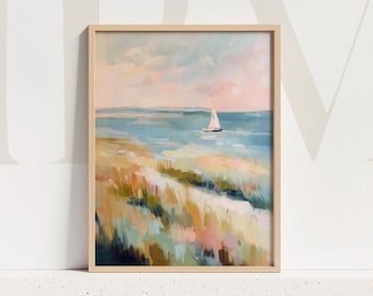 May include: A framed landscape painting featuring a sailboat on the ocean. The artwork uses a palette of soft blues, pinks, and greens to depict a coastal scene. The painting is in a light-colored wooden frame.