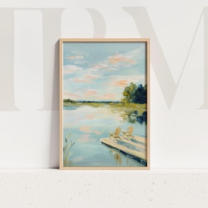 May include: A framed landscape painting depicts a serene lake scene. The artwork features a light blue sky with pink clouds, reflecting in the water. Two wooden chairs sit on a dock, adding a sense of tranquility.