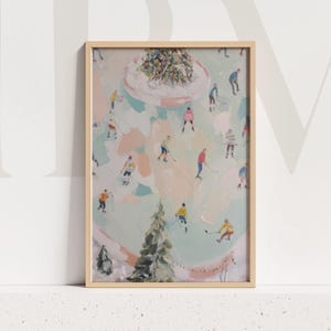May include: A framed art print featuring an abstract winter scene with figures playing hockey on a frozen pond. The artwork has a light color palette with pastel pink, blue, and green hues. A Christmas tree is in the background.