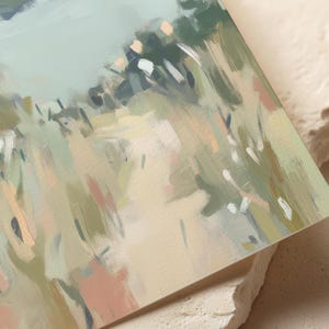 May include: Abstract landscape painting with a palette of soft greens, beige, and touches of pink and peach. The artwork features visible brushstrokes, creating a textured effect. The composition suggests a field or meadow scene, with a focus on natural elements.