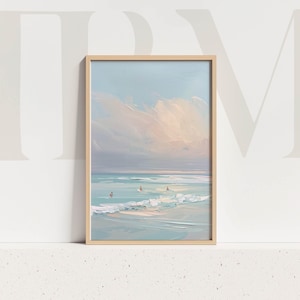 May include: A framed painting of a beach scene. The artwork shows a calm ocean with soft waves and a pastel sky. Several figures are in the water. The frame is a light wood colour, adding a natural touch to the artwork.