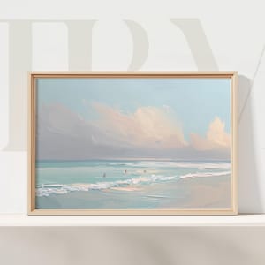 May include: A framed beach landscape painting. The artwork depicts a serene ocean scene with soft blue and turquoise hues, gentle waves, and fluffy clouds. The painting is in a light wooden frame.