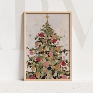 May include: A framed Christmas tree painting. The artwork features a stylized Christmas tree with green, pink, and gold ornaments. A gold star sits atop the tree. The painting is in a light wood frame.