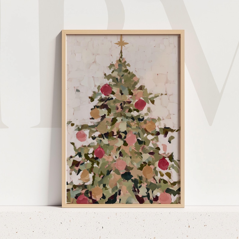 May include: A framed Christmas tree painting. The artwork features a stylized Christmas tree with green, pink, and gold ornaments. A gold star sits atop the tree. The painting is in a light wood frame.
