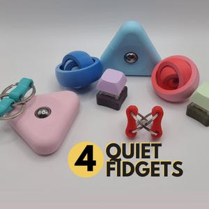 May include: A selection of four brightly coloured fidget toys. These include a pink triangle with a keychain, a blue sphere, a light blue triangle, and a red and pink sphere. The text "4 QUIET FIDGETS" is also visible.