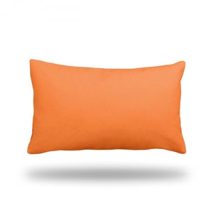 May include: A solid orange rectangular cushion with a smooth, soft surface.